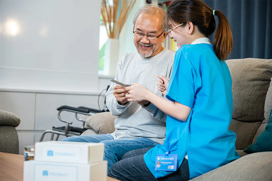 Woman nurse showing elder man medication prescription