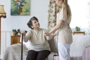 Home care provider in Hingham, MA helping a woman.