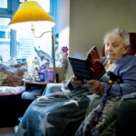 Elderly woman reading a book and enjoying home modifications for aging in place