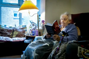 Elderly woman reading a book and enjoying home modifications for aging in place