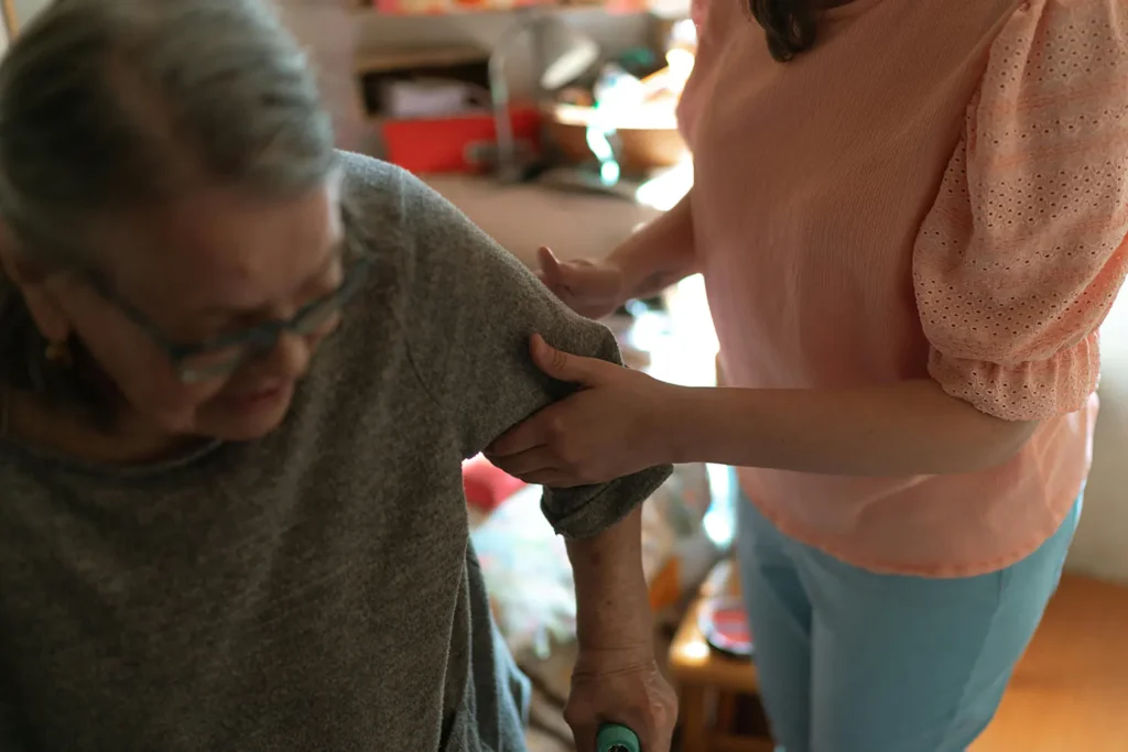 Home care nurse helping elderly woman at home 