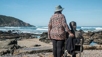Nurse with a woman by the ocean