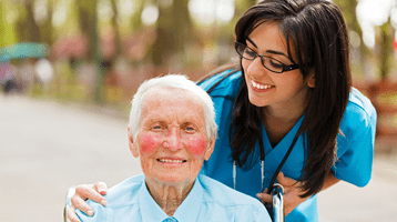 Old man smiling with a happy nurse