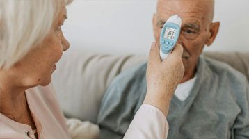 Nurse takes a man’s vital signs.