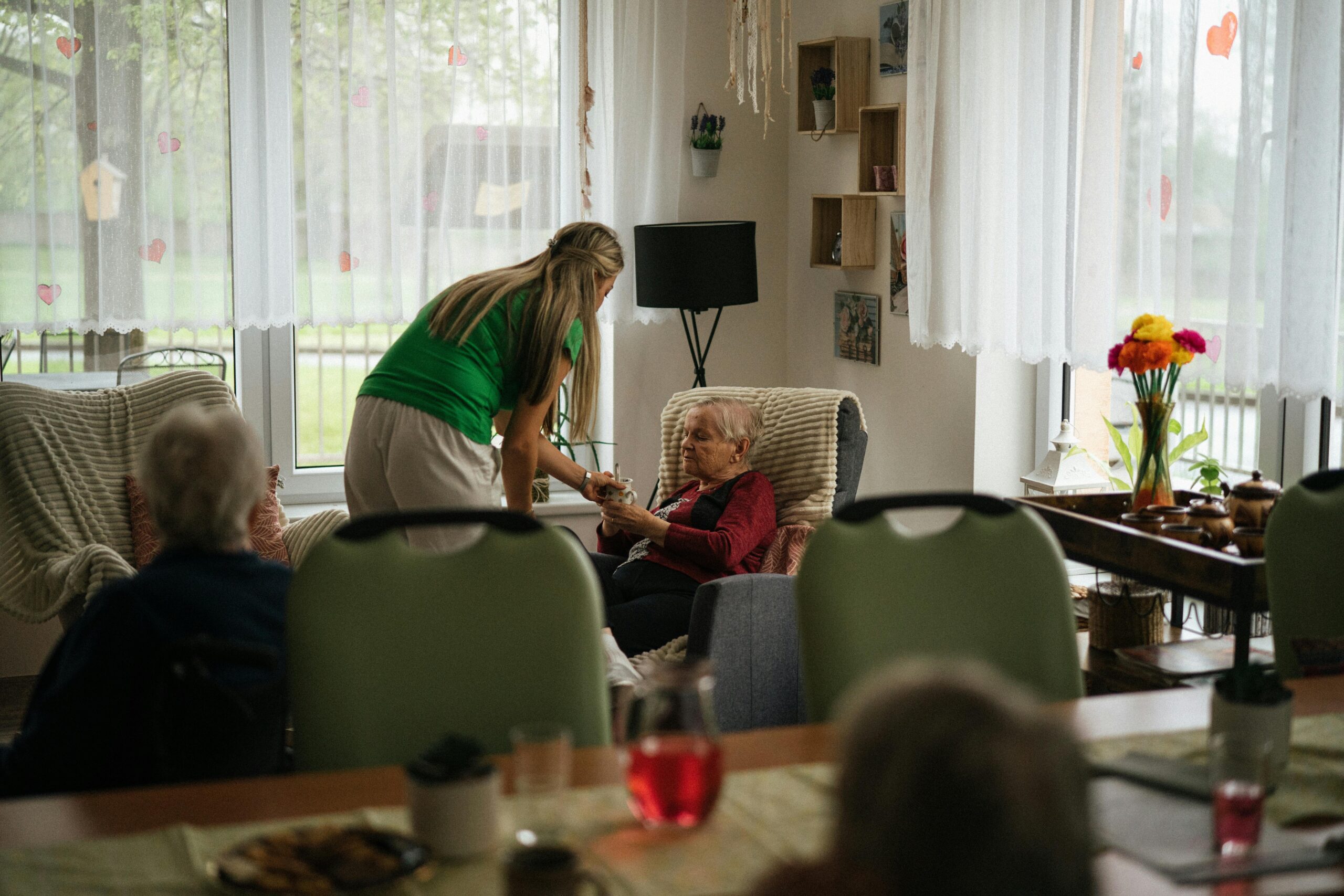 Dementia caregiver helps old woman in her Massachusetts home